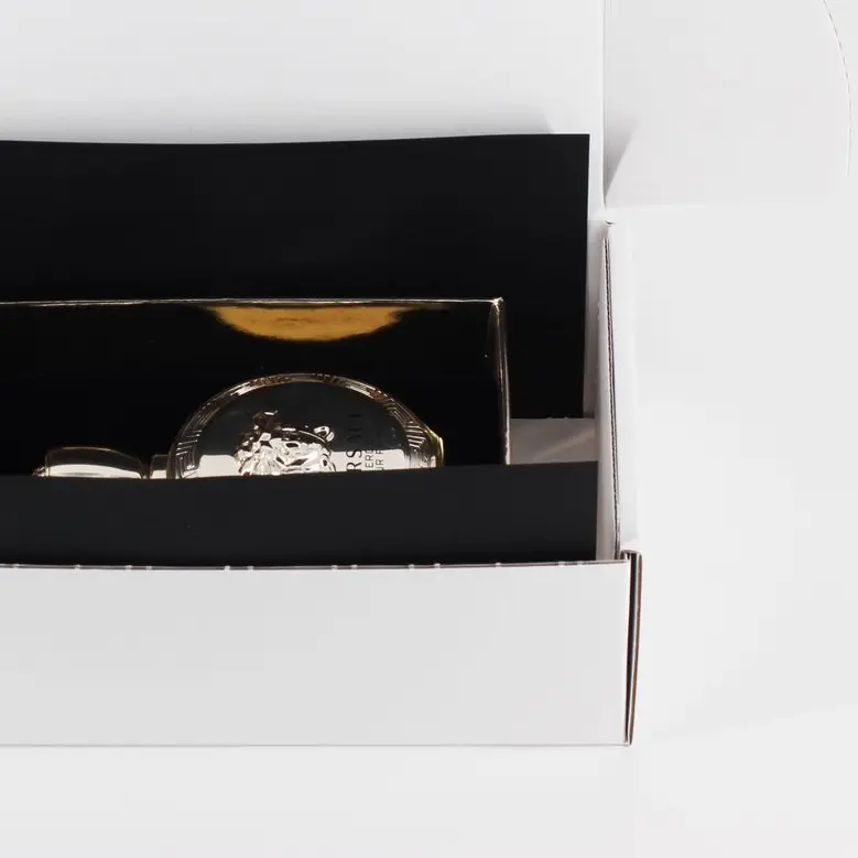 Black paper retention packaging with a bottle of perfume inside